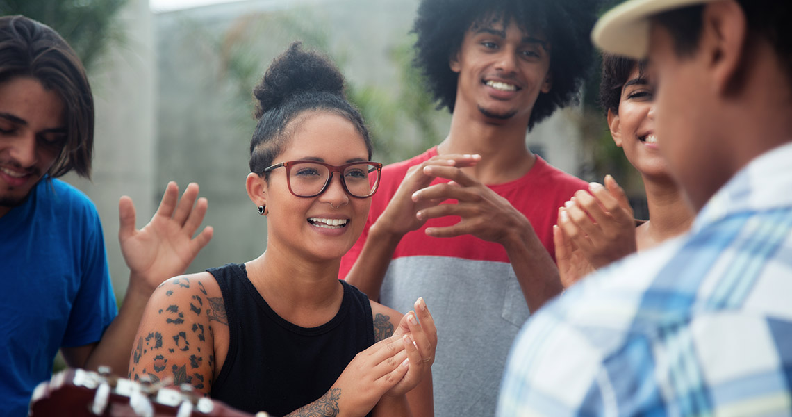 A group of racially diverse young people socialising