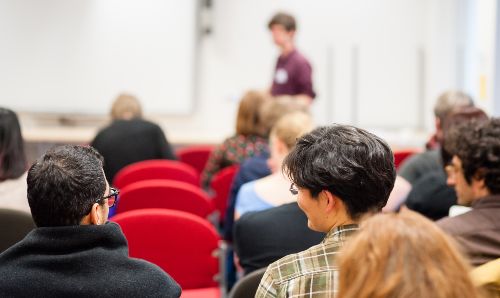 Students talking during a lecture.