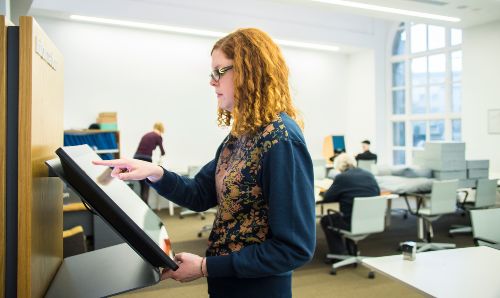 A female student looking at a screen.