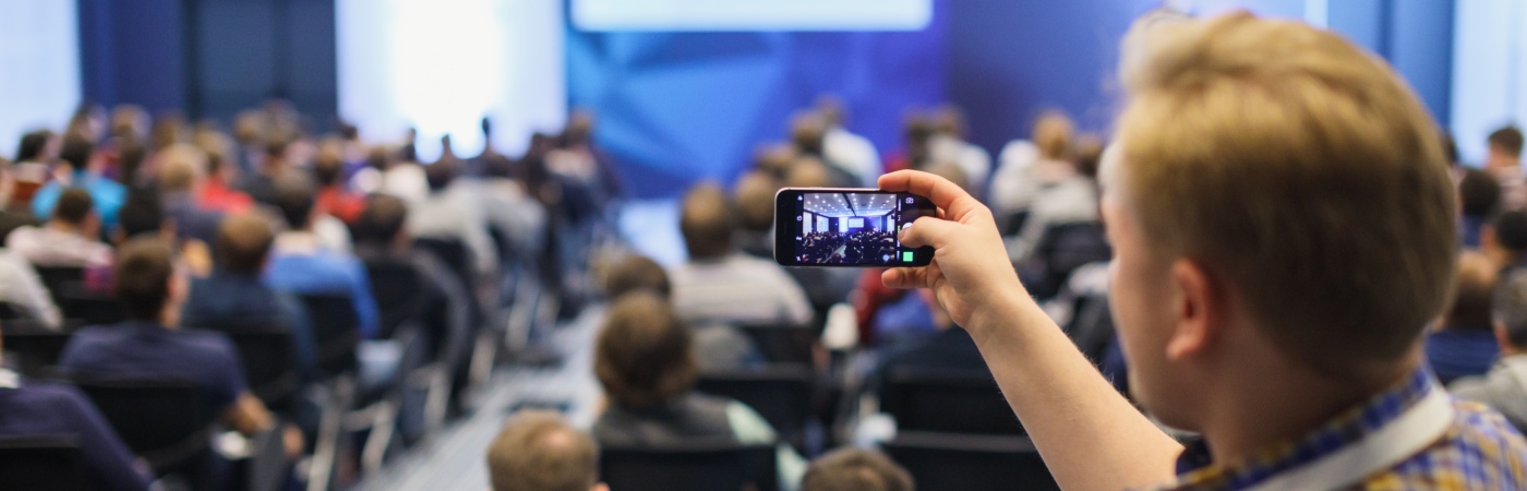 Student taking a photo of a lecture 