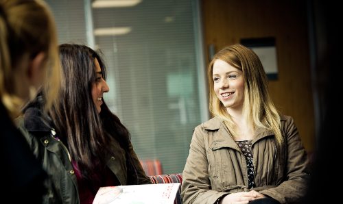 A female Criminology student talking with fellow students 
