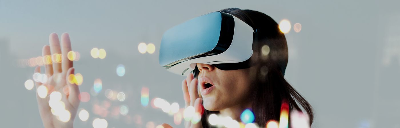 Woman wearing a virtual reality headset with balls of light surrounding her.