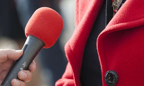 Person holding microphone.