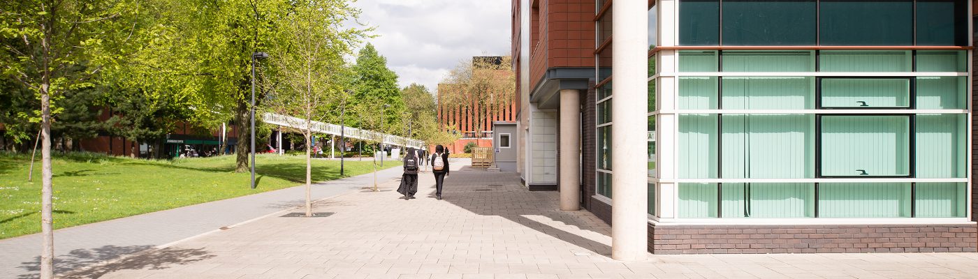 people walking by Arthur Lewis building