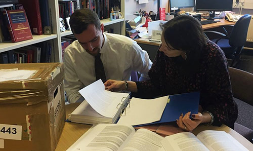 James Perry looking through legal files with Professor Claire Mcgourlay.