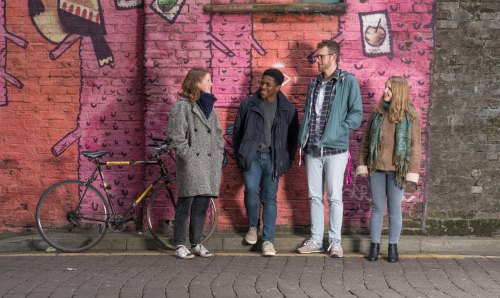 Students stood in front of painted wall