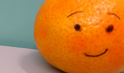 Smiley face drawn on an orange