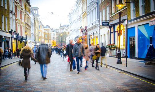 Shoppers walking down a London high street.