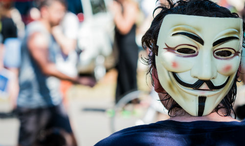 Man in a Guy Fawkes mask.