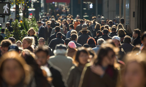 Crowd of people walking in a city centre