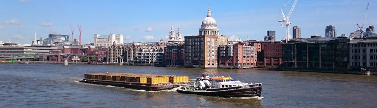 A cargo ship travelling on the Thames.