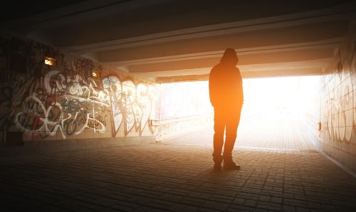 Silhouette of a man in a subway tunnel. 