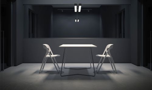 Interrogation room with two, empty white chairs. 