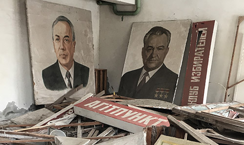 Poster images of two men in building ruins