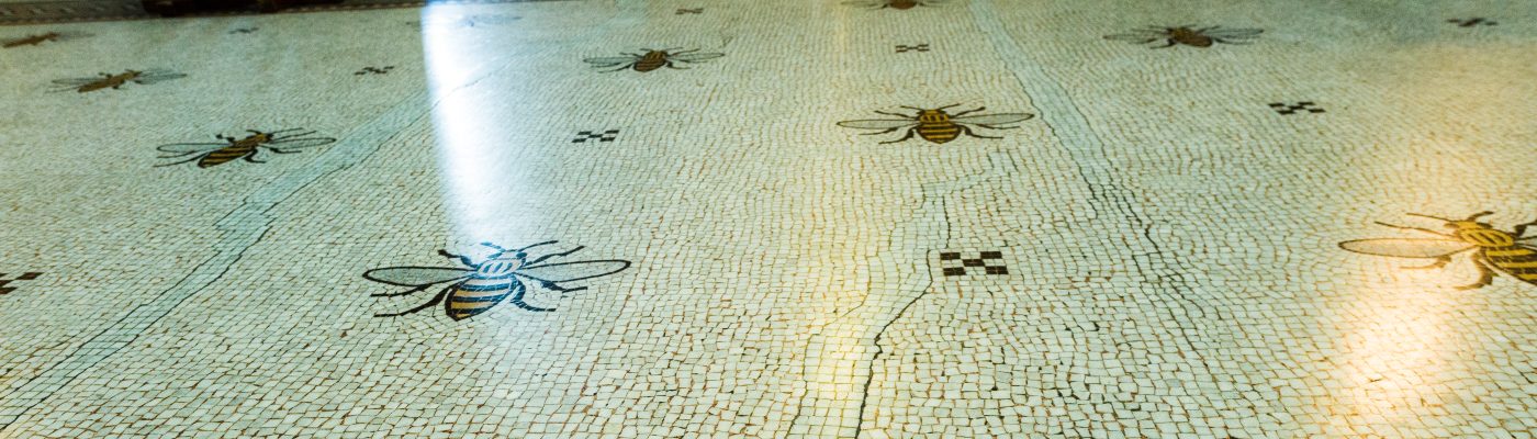 A tiled floor with pictures of bees. 