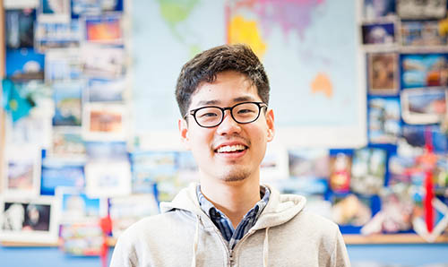 international student with postcards in the background