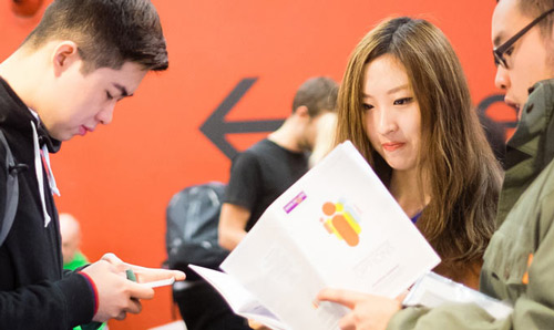 students reading through information leaflets