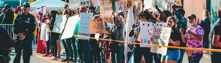 Demonstrators stood behind police line holding up banners